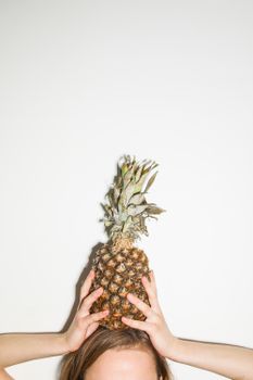有人开玩笑地把新鲜菠萝举过头顶，象征着乐趣与健康的生活