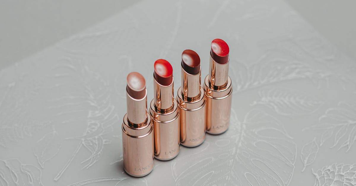 A stylish set of lipsticks arranged on a decorative textured surface, perfect for fashion and beauty themes. A stylish set of lipsticks arranged on a decorative textured surface, perfect for fashion and beauty themes.