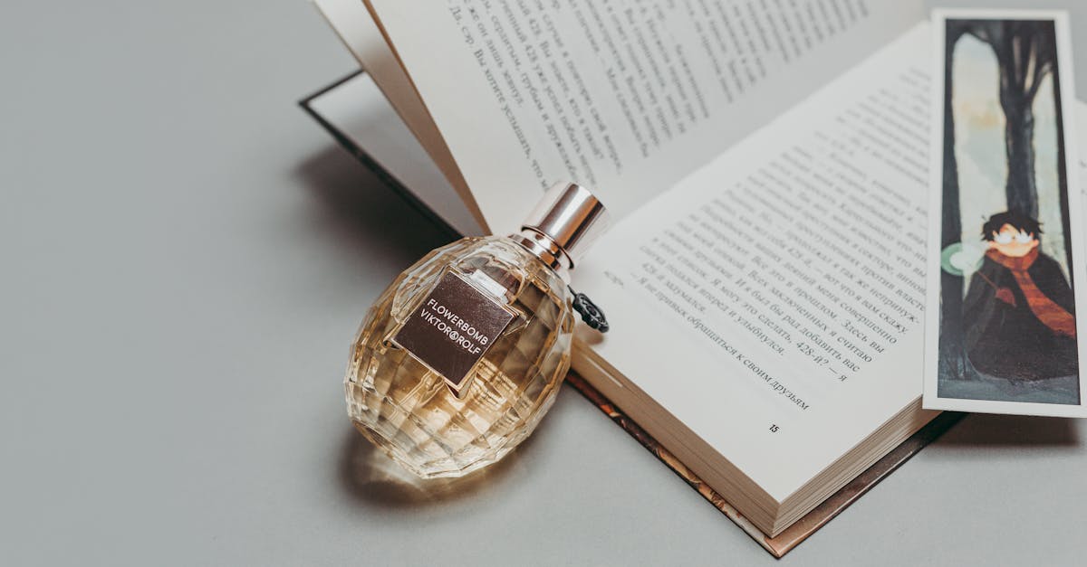 Photo Of Perfume Laying On Book · Free Stock Photo