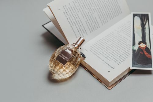 Free An artistic flat lay of a book, perfume bottle, and bookmark for a luxury and literary concept. Stock Photo
