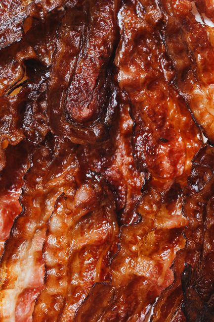 How to bake bacon in the oven for evenly crisp strips with no stovetop splatter - temperature, timing, and cleanup tips.