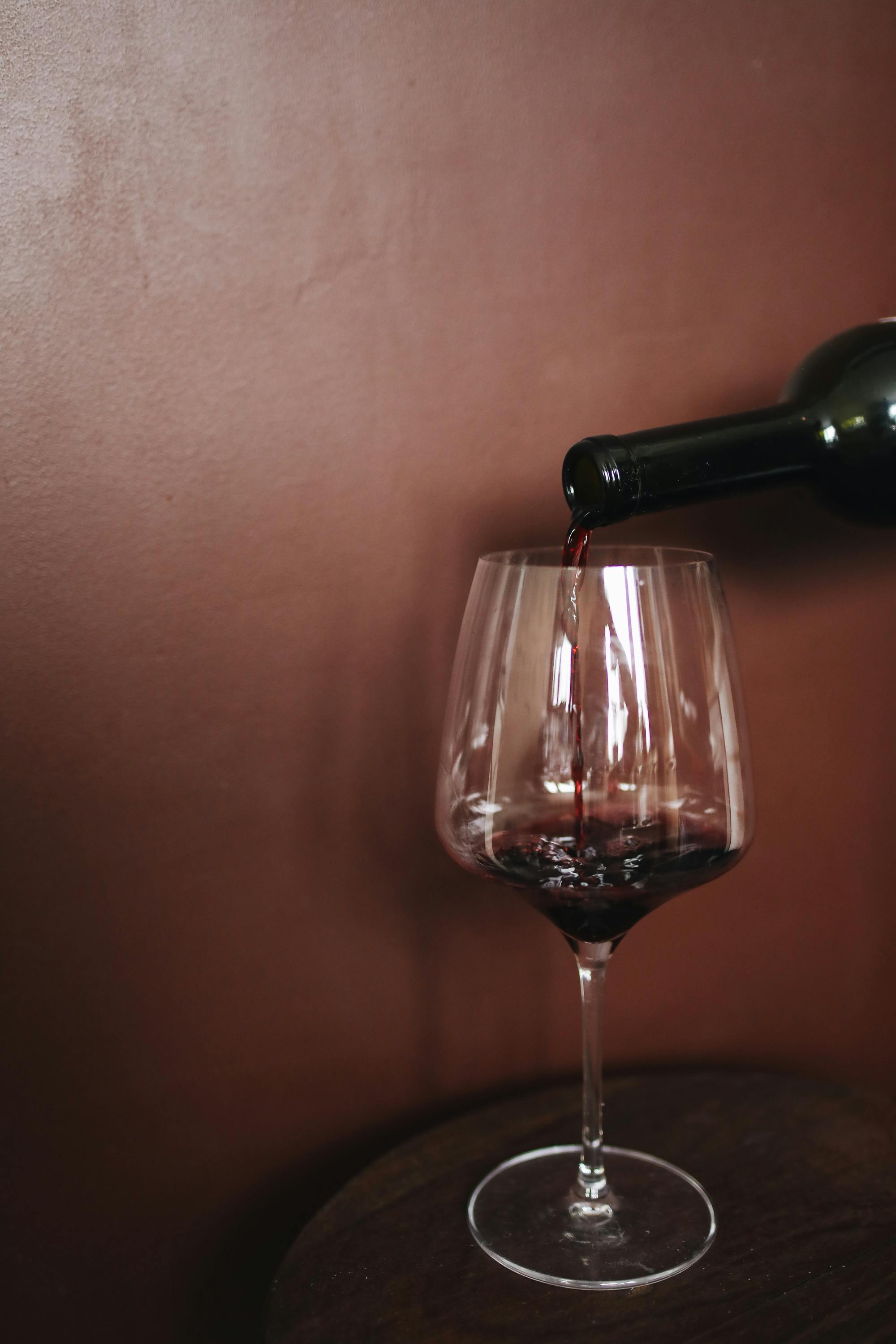 Glass Of Cheap Red Wine With A Drinking Straw On A Reflective Silver Table  With White Background. Stock Photo, Picture and Royalty Free Image. Image  5436658.