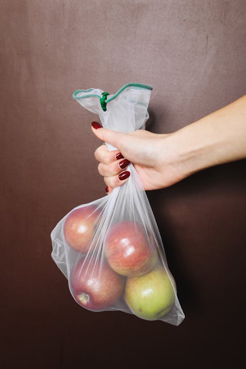 Free Photo Of Person Holding Bag Of Apples Stock Photo