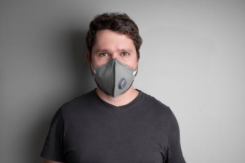 Man in Black Crew Neck Shirt Wearing a Mask