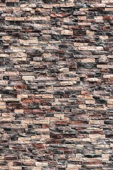A detailed close-up view of a natural stone brick wall texture for design purposes.
