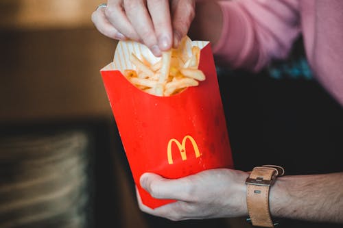 Photo Of Person Holding Fries