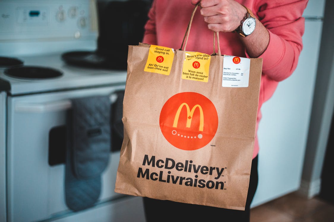 Free Man Holding A Mcdonald's Paper Bag Stock Photo