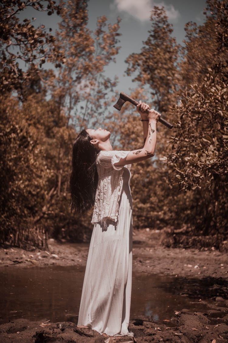 Tranquil Woman With Axe In Forest