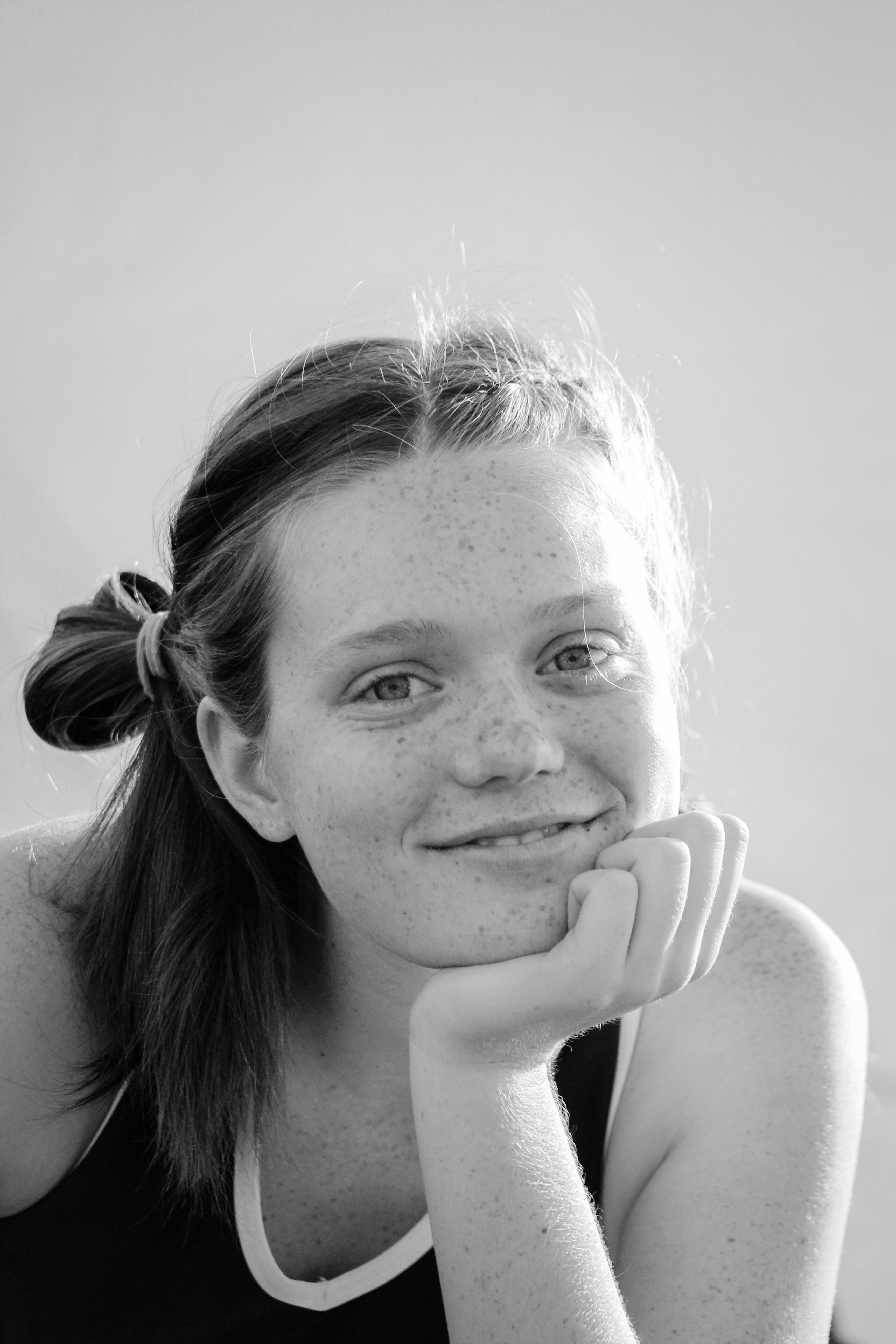 monochrome photo of girl holding her chin