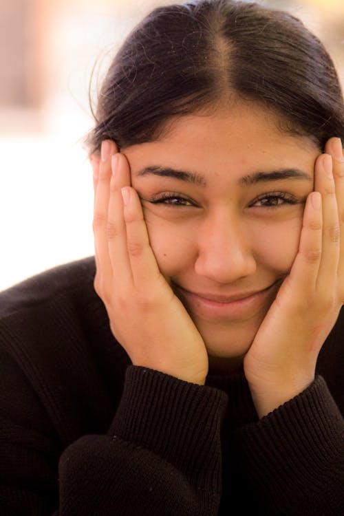 Close-Up Photo Of Woman Touching Her Face