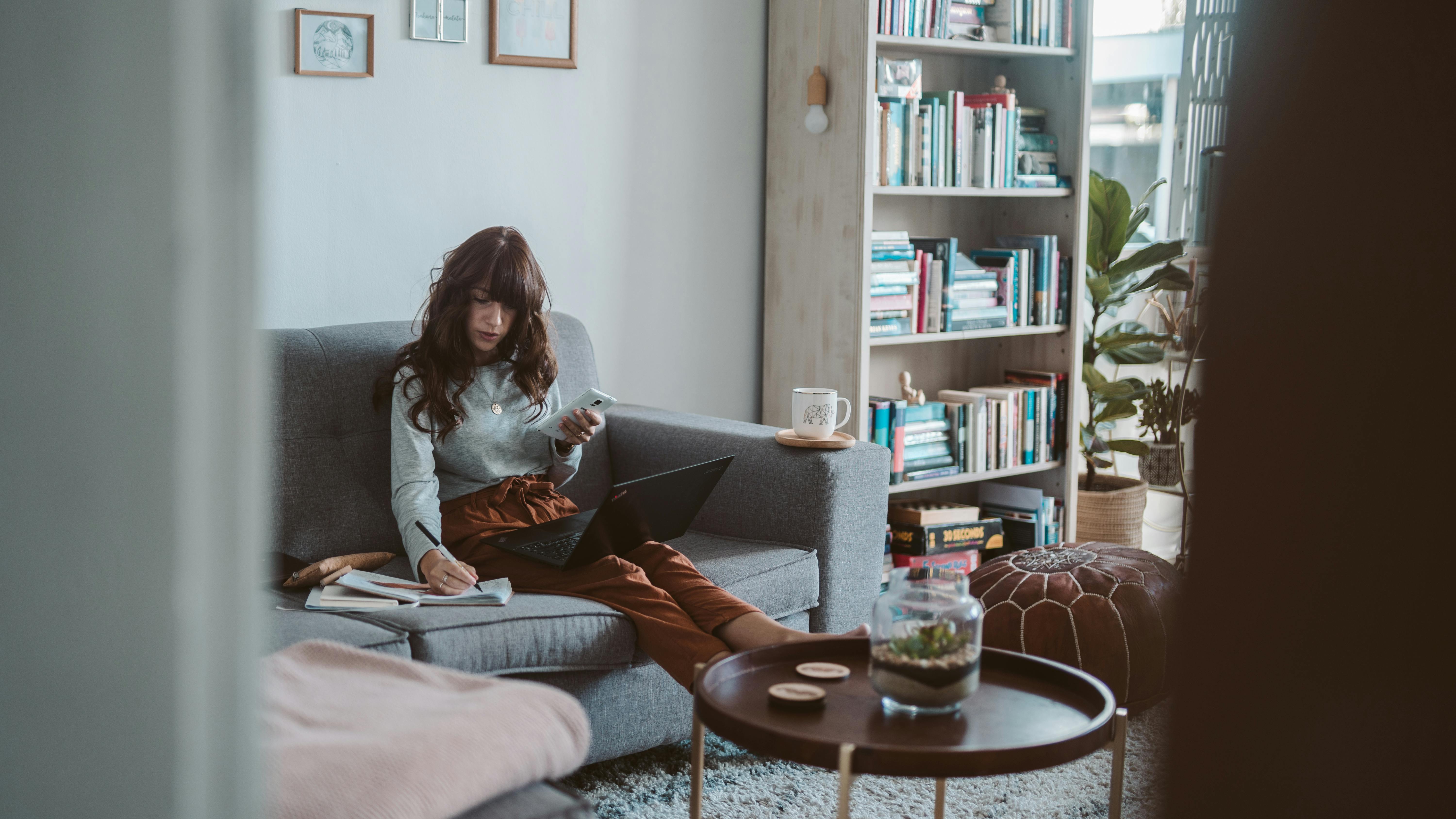 photo of woman sitting on couch