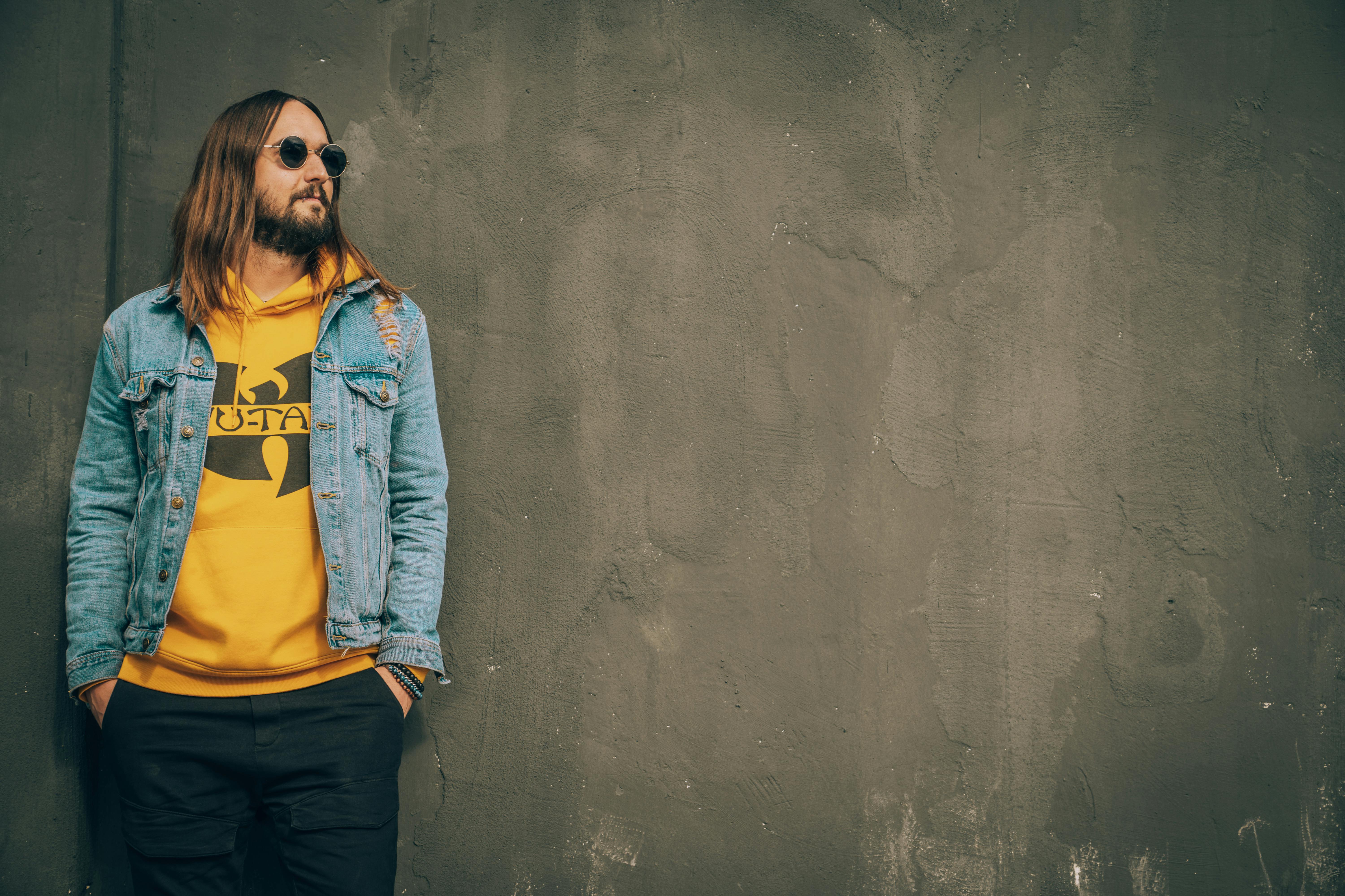 Rear View of Man Wearing Denim Jacket in City · Free Stock Photo