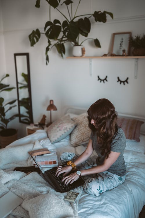 Free Photo Of Woman Sitting On Bed Stock Photo