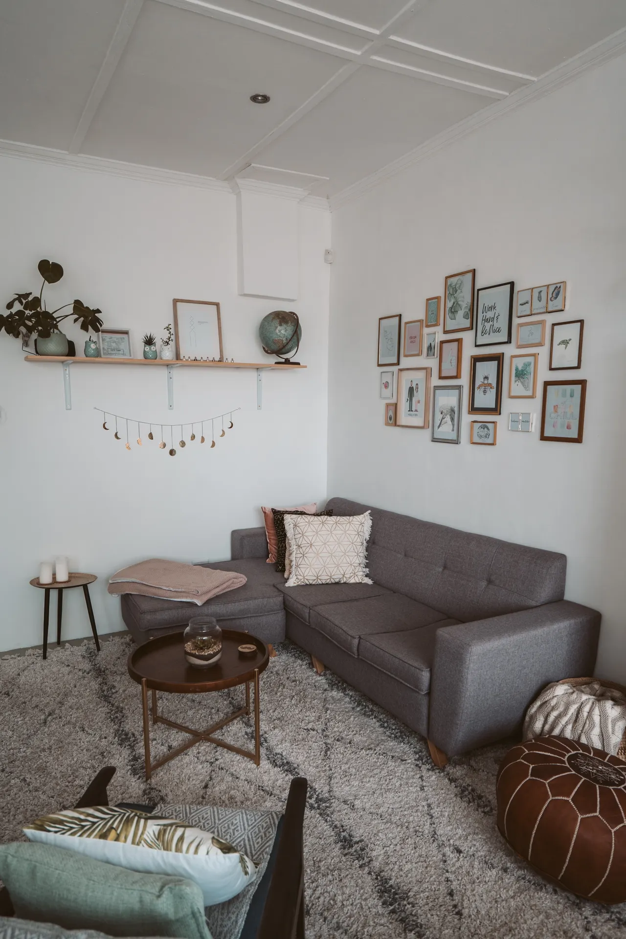 mirror-shelf-combo-above-couch Above couch wall decor ideas: modern living room with floating shelf, plants and framed art above a grey sofa