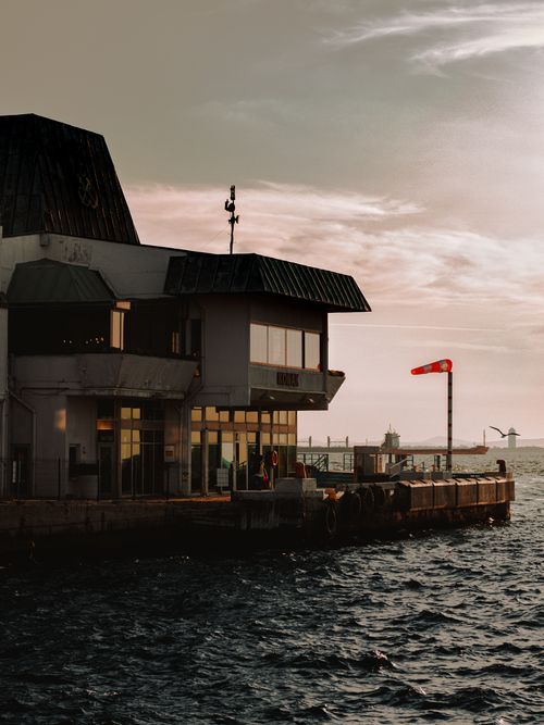 Free A serene view of the waterfront in Izmir, Turkey at sunset, capturing the pier and sea. Stock Photo