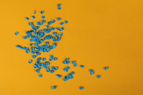 Blue Confetti on Yellow Surface