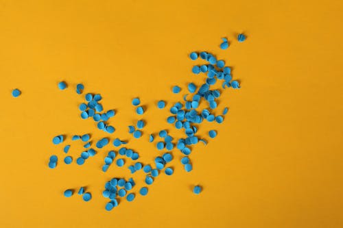 Blue Confetti On Yellow Background