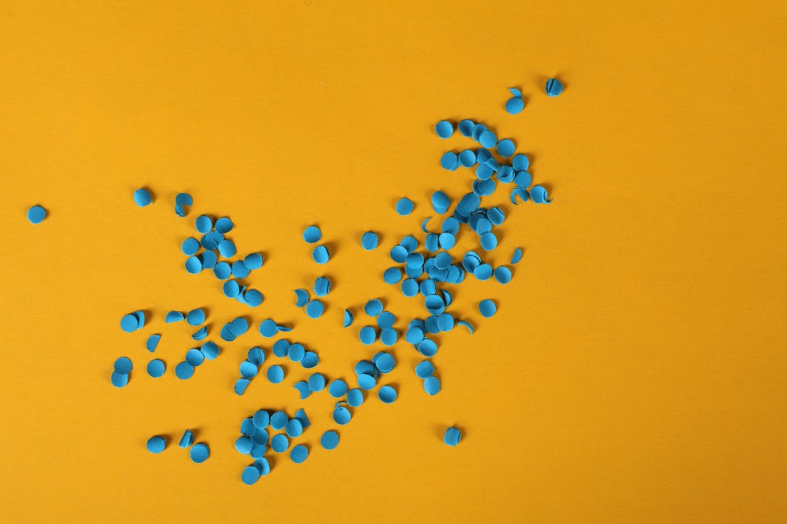 Blue Confetti On Yellow Background