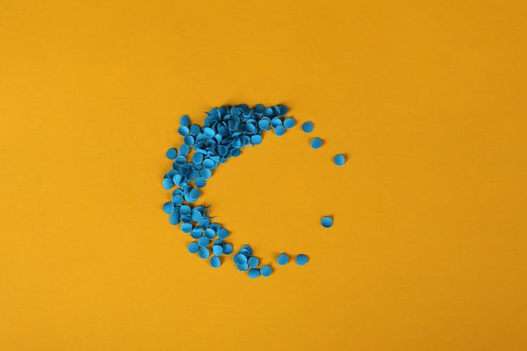 Blue Confetti On Yellow Background