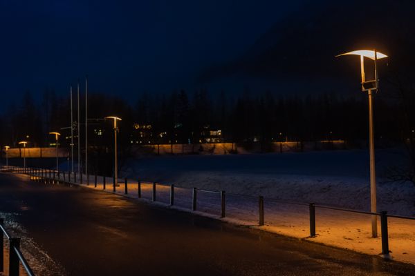 Street lamps on a deserted snowy road at night — Castorly Stock on Pexels