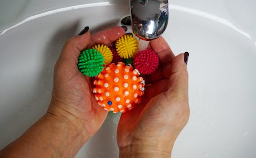 Person Washing Colorful Rubber Balls