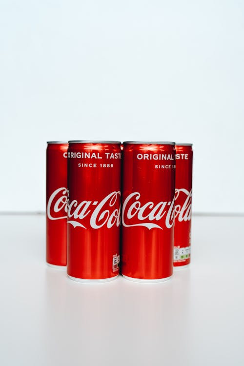 Coca Cola Cans on White Table