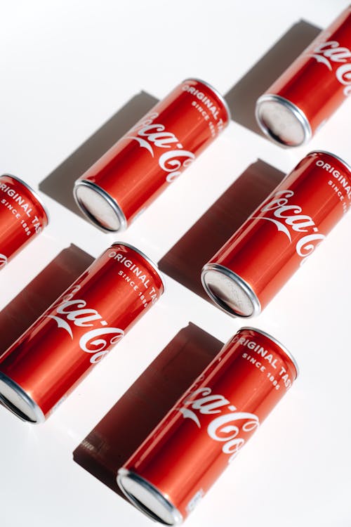 Coca Cola Cans on White Table