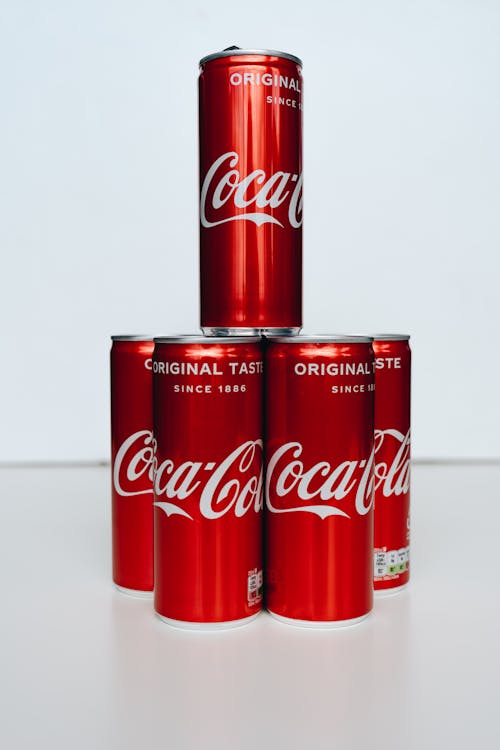 Coca Cola Cans on White Table