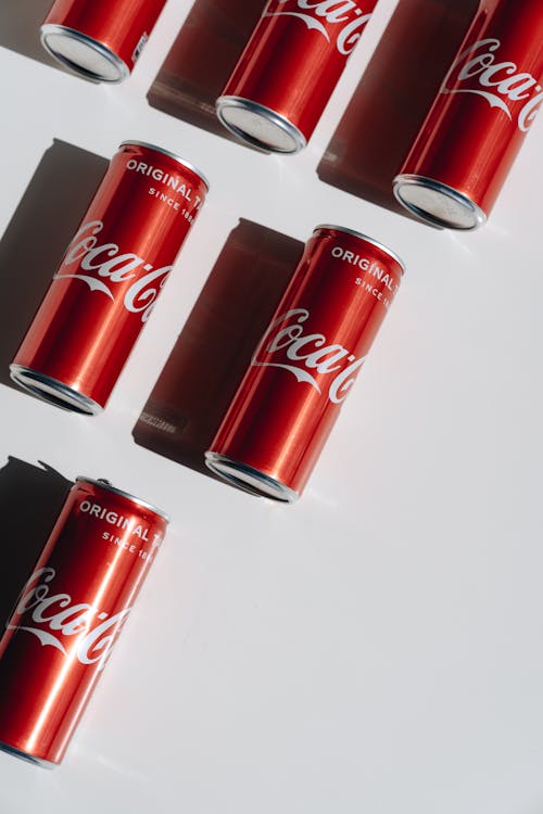 Coca Cola Cans on White Table