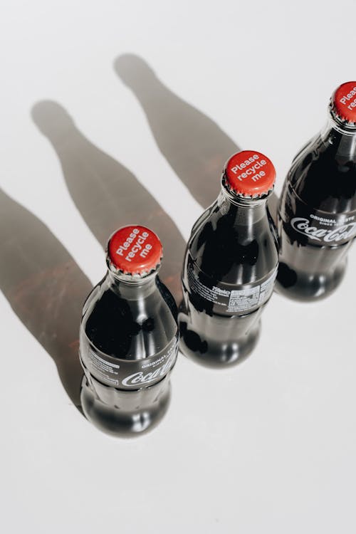 Free Coca Cola Bottles on White Table Stock Photo