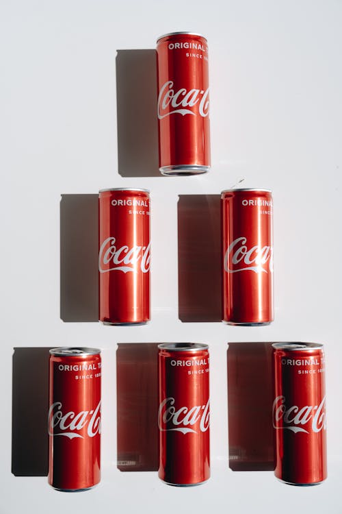 Coca Cola Cans on White Table