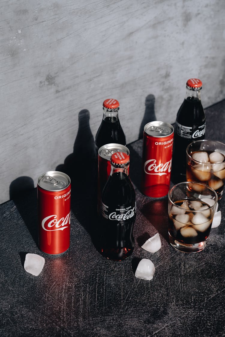 Glasses, Cans And Bottles Of Coca Cola