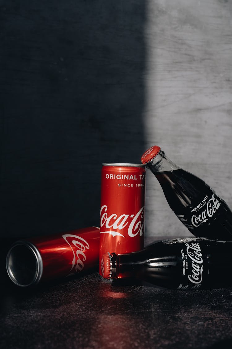 Close-Up Photo Of Canned And Bottled Soft Drinks