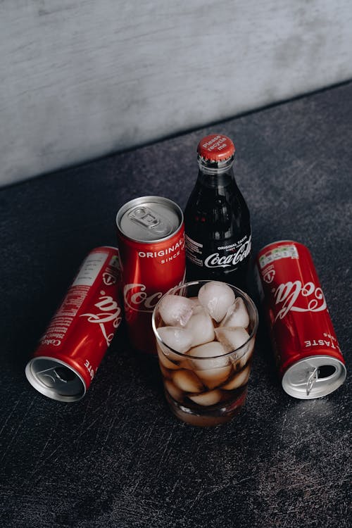 Free Photo Of Canned Soft Drinks Near Glass Stock Photo