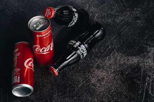 Close-Up Photo Of Canned and Bottle Soft Drinks