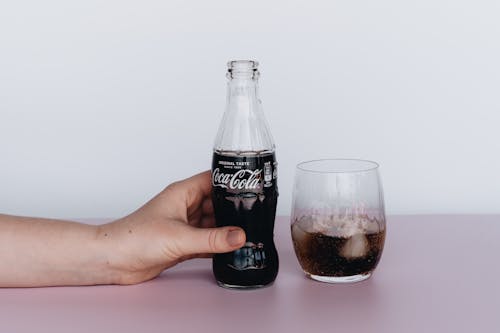 Free Photo Of Person Holding Bottled Soft Drinks Stock Photo