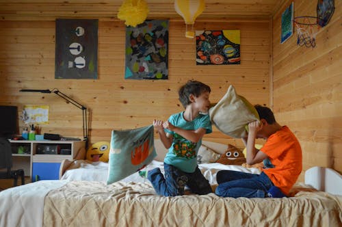 Photo Of Boys Holding Pillows