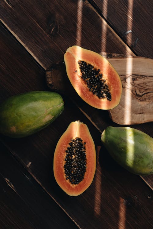 Free Photo Of Papaya On Top Of Wooden Surface Stock Photo