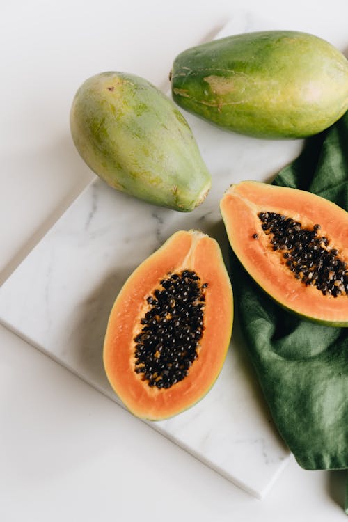 Photo Of Sliced Papaya On Top Of Marbled Surface