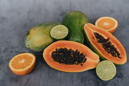 Close-Up Photo Of Sliced Papaya Beside Sliced Lime