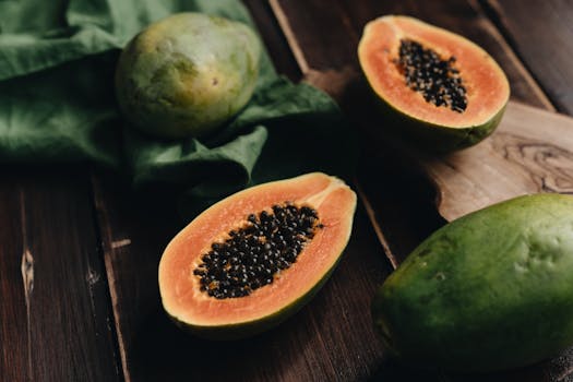 Delicious sliced papaya on a wooden board, showcasing fresh tropical fruit for healthy eating.
