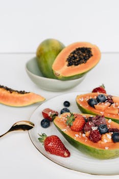 Enjoy a vibrant and healthy breakfast with fresh papaya, strawberries, blueberries, and raspberries.