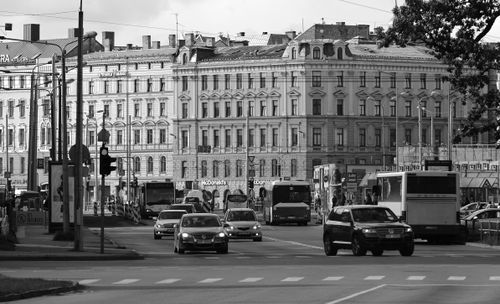 Free Black and white of big street with multi storey building and bus and cars on road Stock Photo