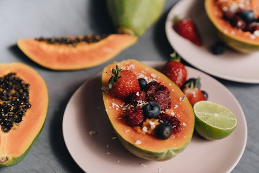 A vibrant photo of a tropical fruit bowl with papaya, berries, and lime, perfect for healthy eating.
