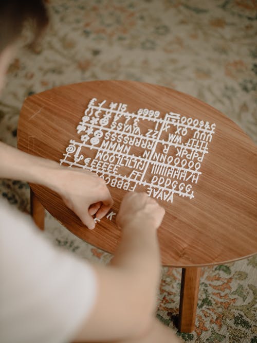 Person Holding Brown Wooden Heart Shape Table