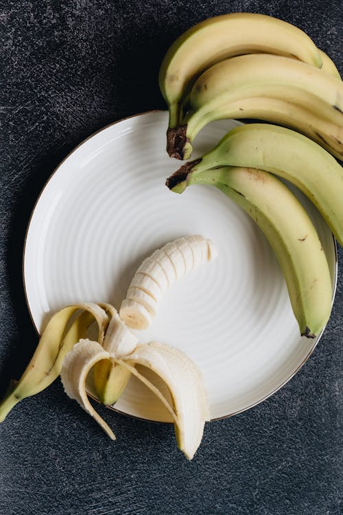 Fresh cut bananas on white plate