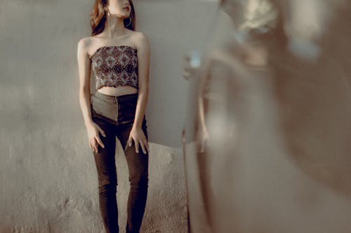 Woman in Blue Denim Jeans and White Floral Tube Top