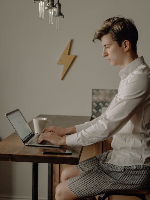 Man in White Dress Shirt Using Black Laptop Computer