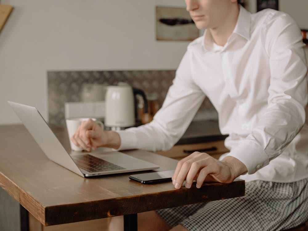 Man in White Dress Shirt Using Macbook Pro