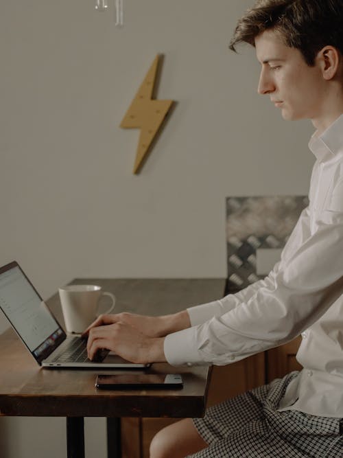 Man in White Dress Shirt Holding Black Tablet Computer